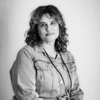 a black and white photo of a woman in a denim jacket